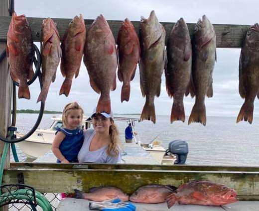 Mom and daughter saying yummm after a trip with Hookedup Charters