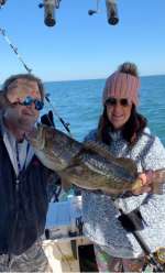 Mrs. M. with her first grouper with Captain John