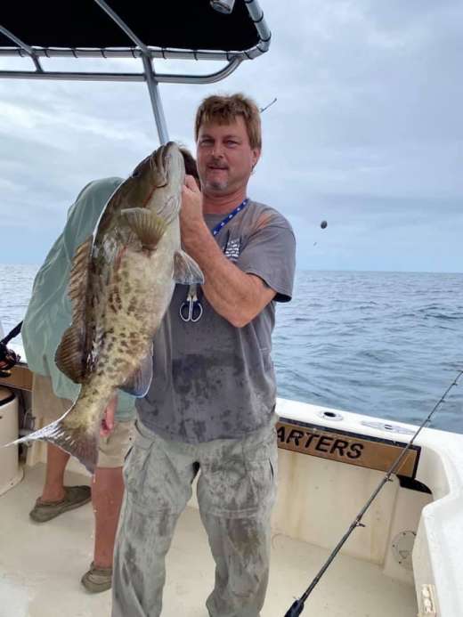 Captain John sporting a nice Gag Grouper on a Hookedup Charters trip