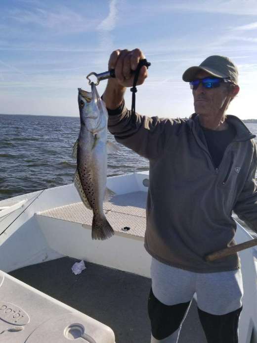 Captain Kyle's crew showing off a nice trout