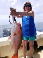 Susan with a monster Red Snapper caught with Hookedup Charters