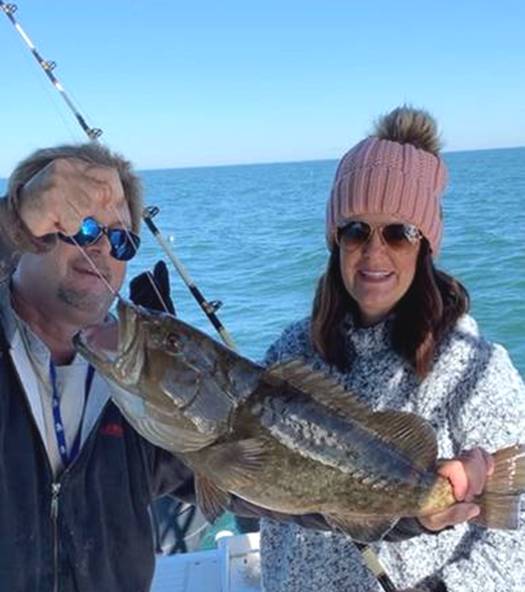 Mrs. M. with her first grouper with Captain John